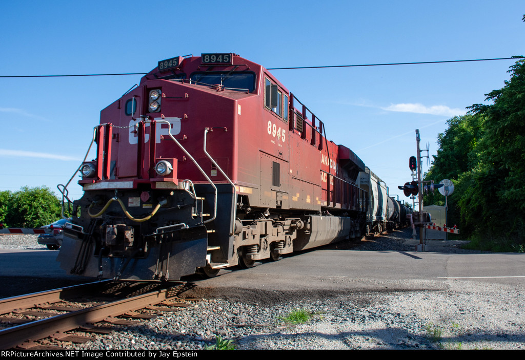 CP 8945 shoves an oil train south at Farmington Road 